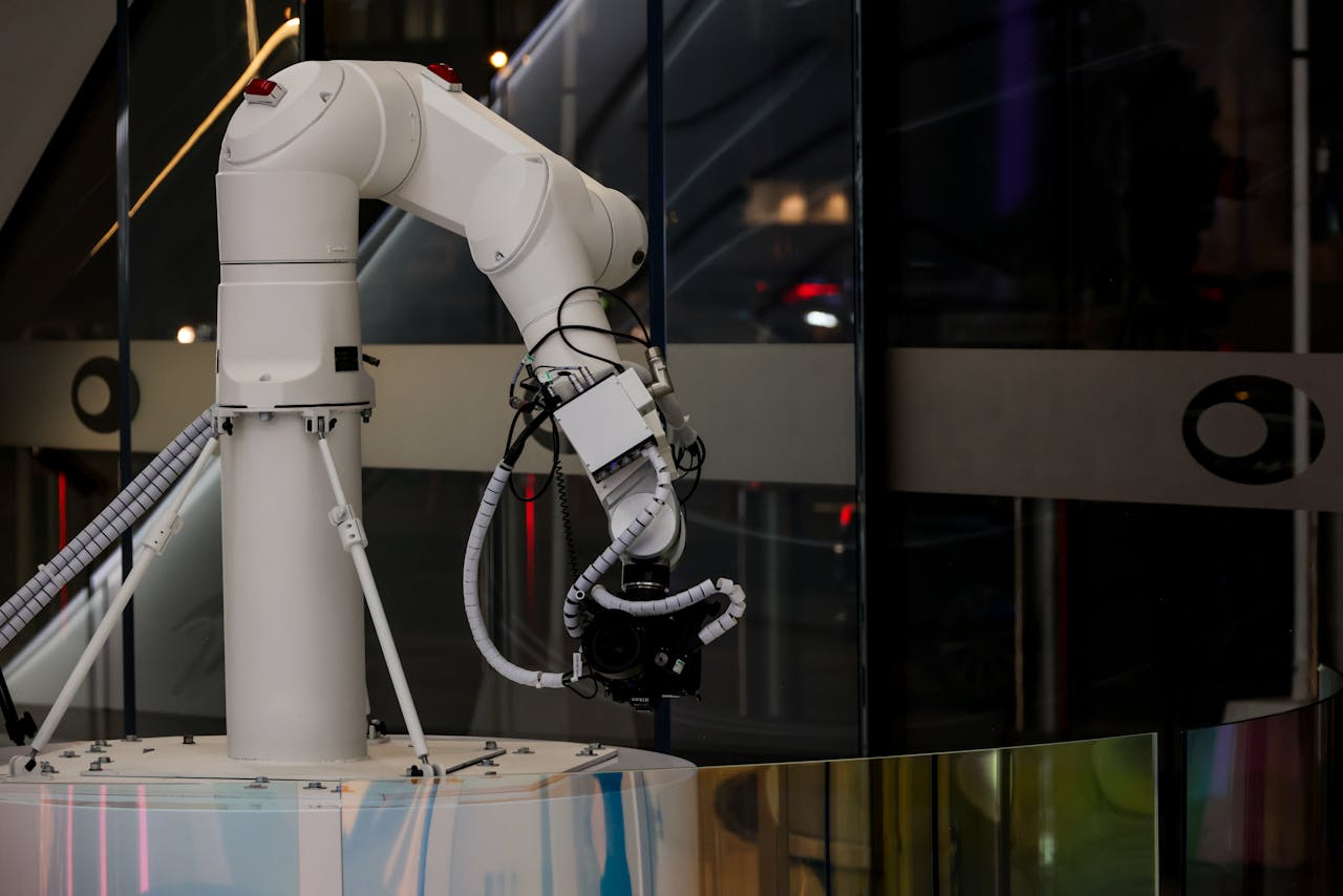 Mastering the First Impression: Your intriguing post title goes here A white robotic arm operating indoors with a modern design and advanced technology.