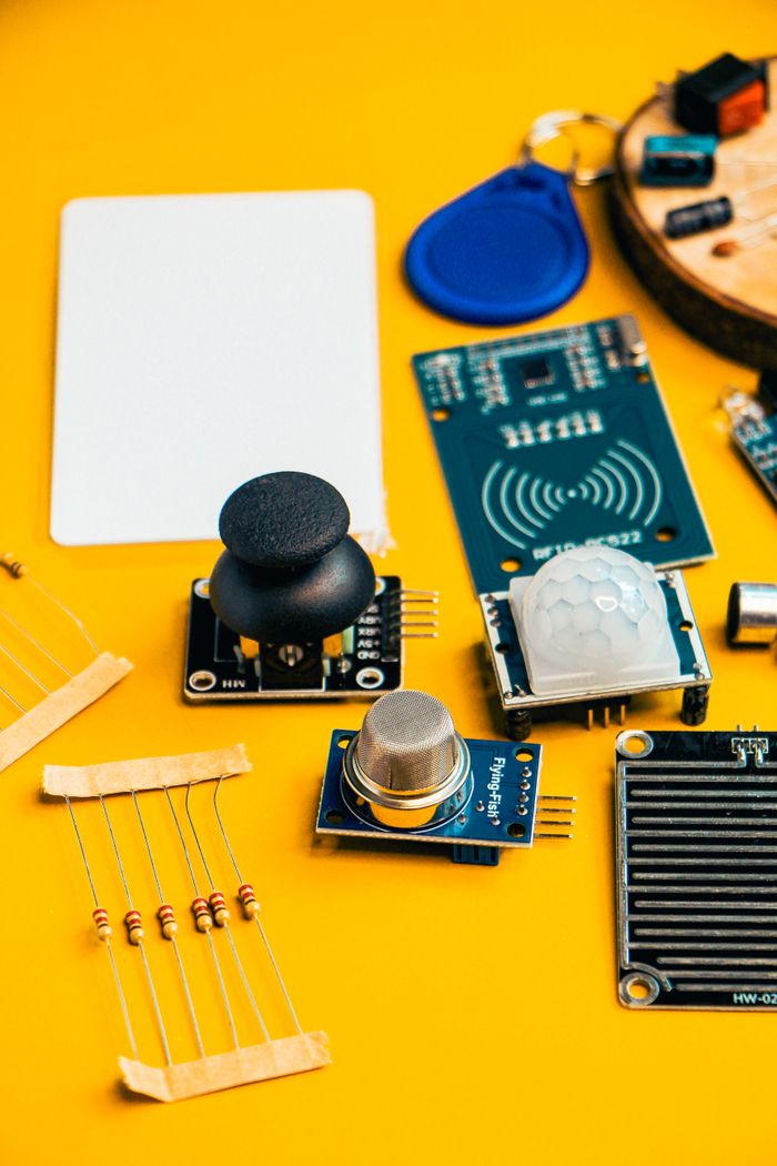 The Art of Drawing Readers In: Your attractive post title goes here A top-down view of various electronic components and sensors on a vibrant yellow surface.